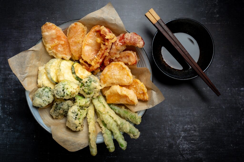 Flat lay of Japanese vegetable tempura recipe with ginger ponzu sauce